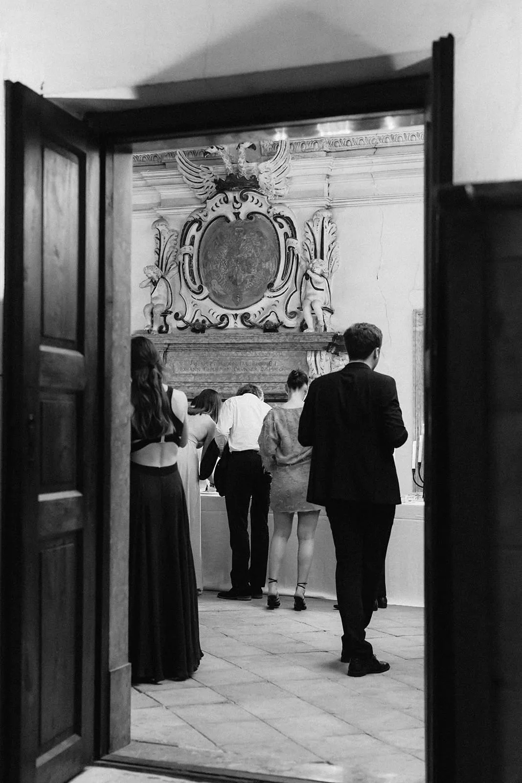 Guests at the dessert table, seen through the open double doors