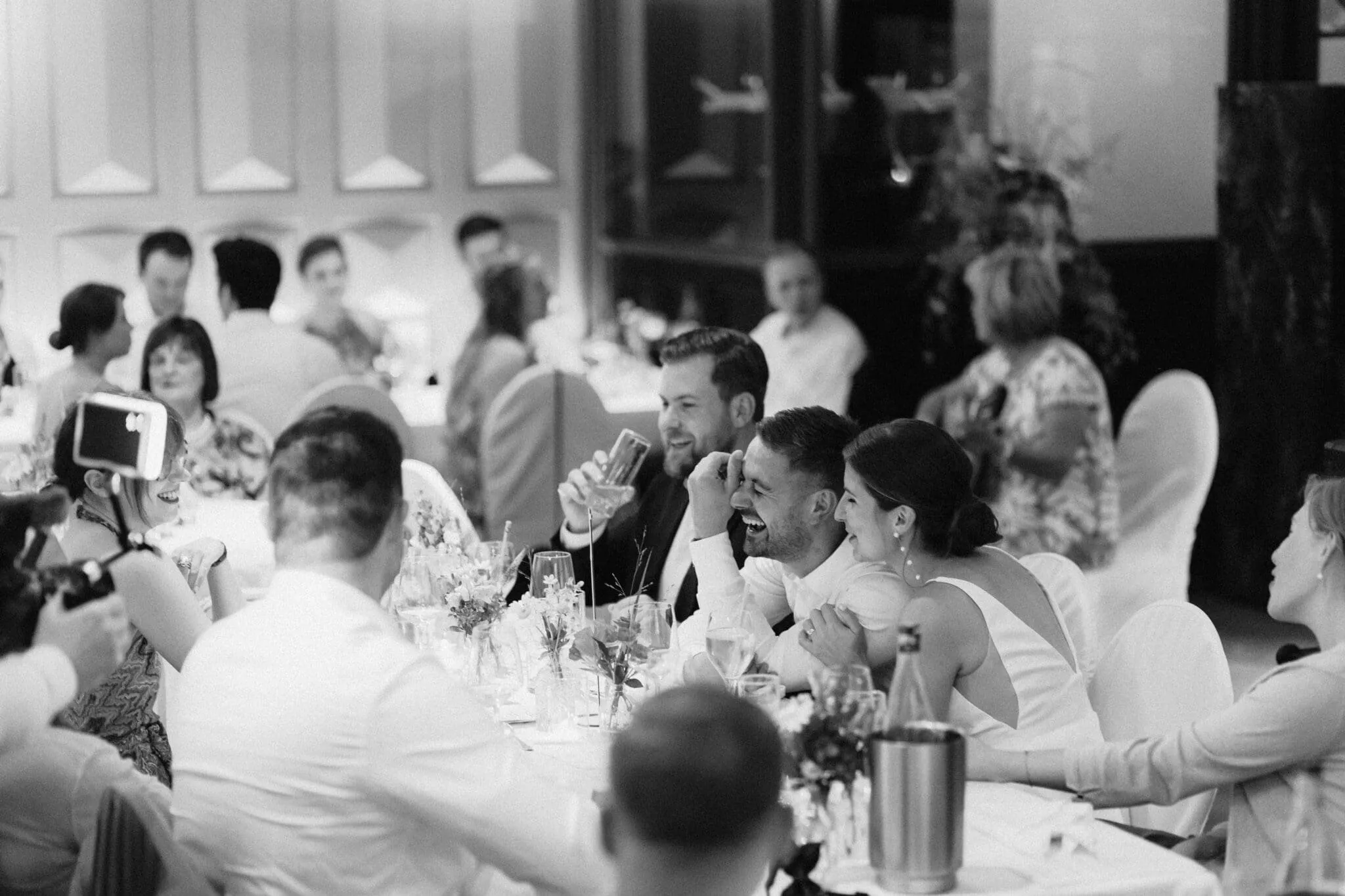 Guests raising their glasses around a long table