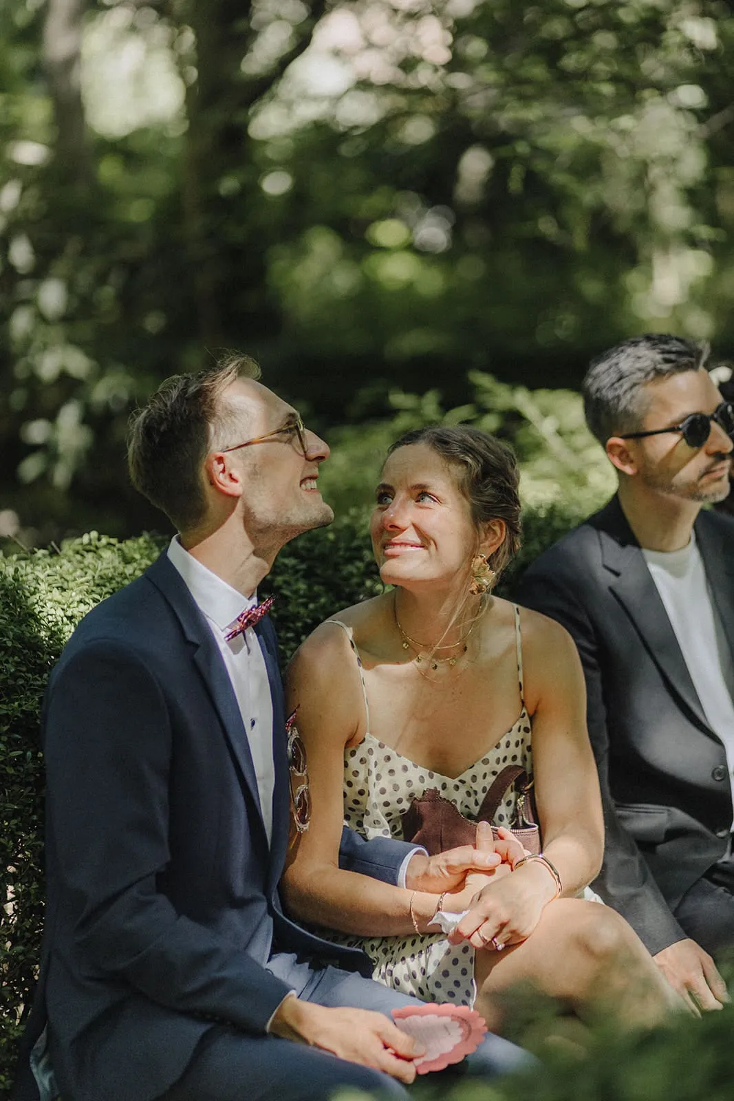 Two guests looking up during the ceremony, laughing